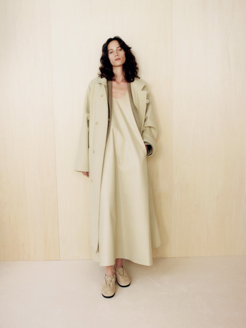 Liz wears Double Cloth Super Fine Melton Coat in Light Beige, Light Lamb Leather Dress in Light Beige, Lamb Suede Cord Shoes Made by Foot The Coacher in Beige